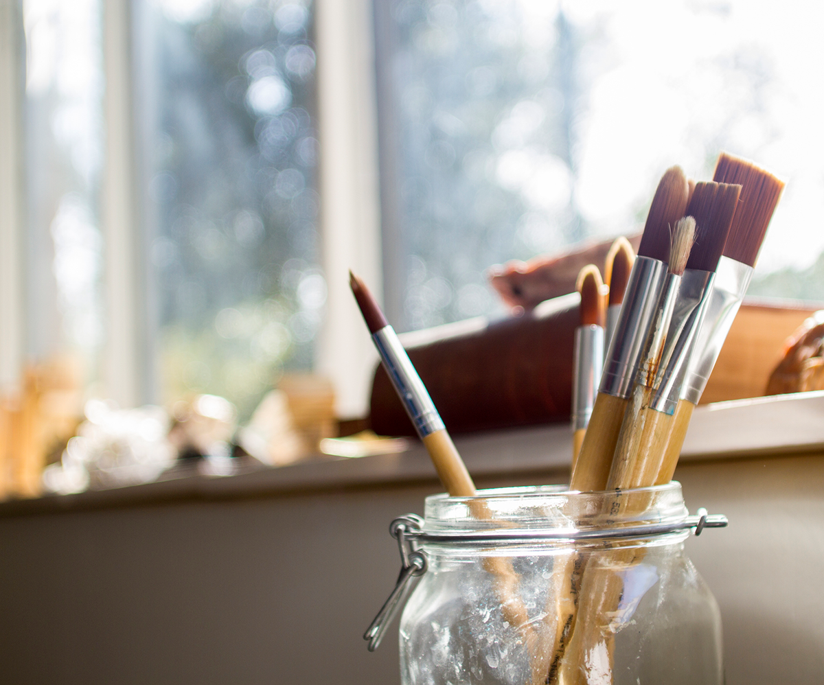 Mason jar with paintbrushes. Graphic Design.